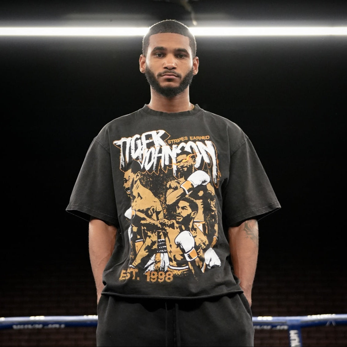 Tiger Johnson wearing black Raw Faded Oversized Tiger Johnson Supporter Tee