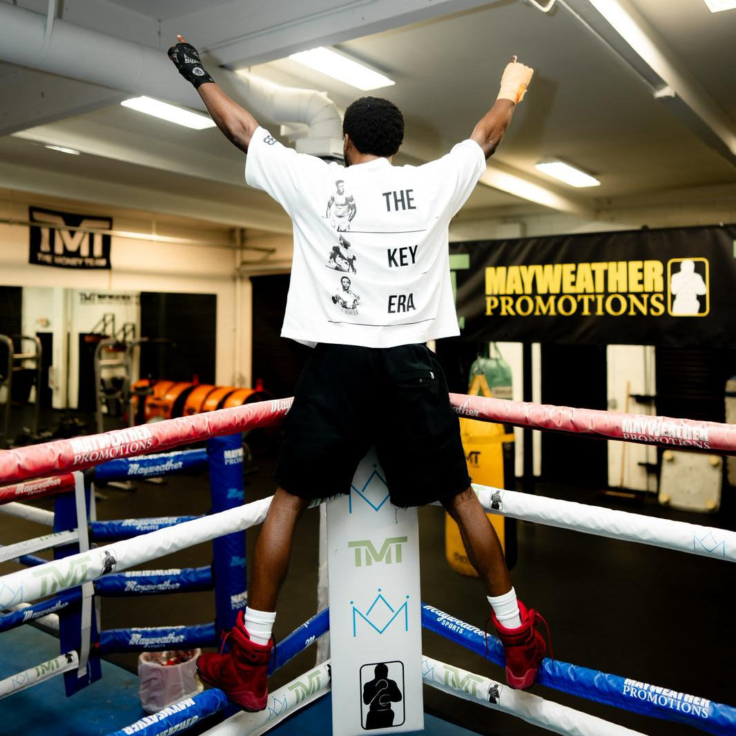 Back view of Keyshawn Davis wearing limited edition white oversized Keyshawn Davis "Evolution" t-shirt