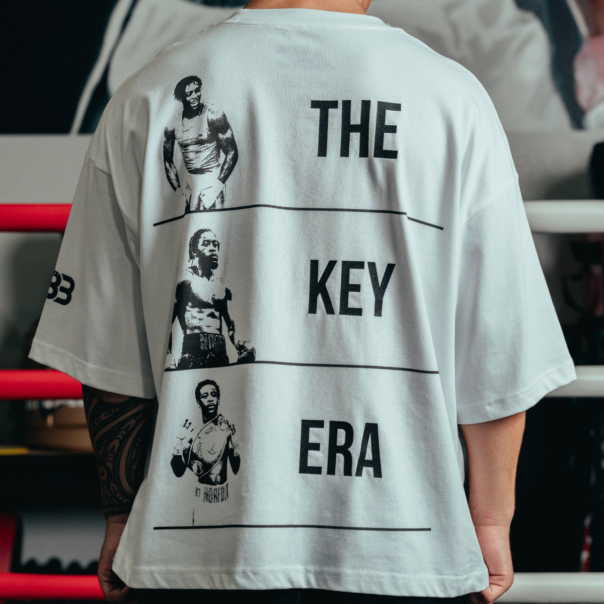 Back view of model wearing Keyshawn Davis “Evolution” Tee - Limited Edition
