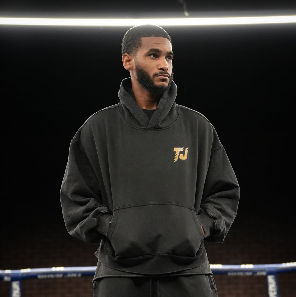 Front view of Tiger Johnson wearing black vintage washed oversized Tiger Johnson Supporter Hoodie