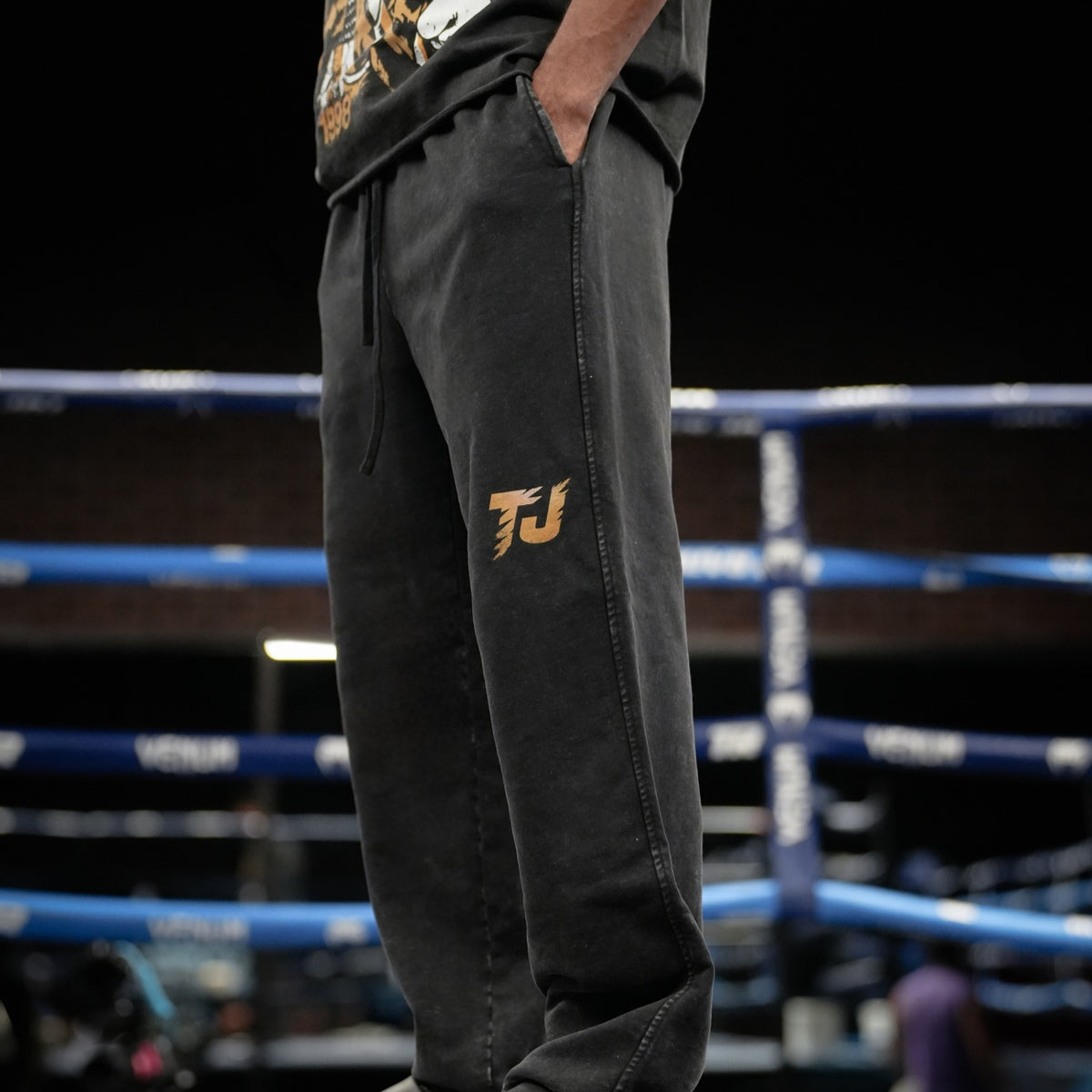 Front view of Tiger Johnson wearing black relaxed washed and distressed Tiger Johnson Supporter Sweatpants